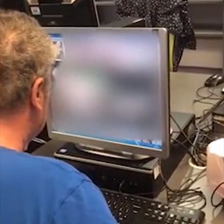 Man van middelbare leeftijd kijkt porno in een openbare bibliotheek